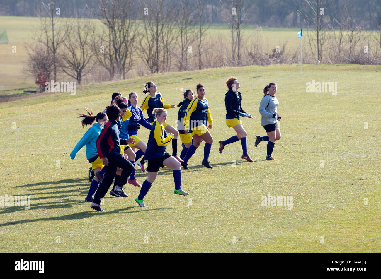 University sport, women`s footballers doing warm-up exercises before match Stock Photo